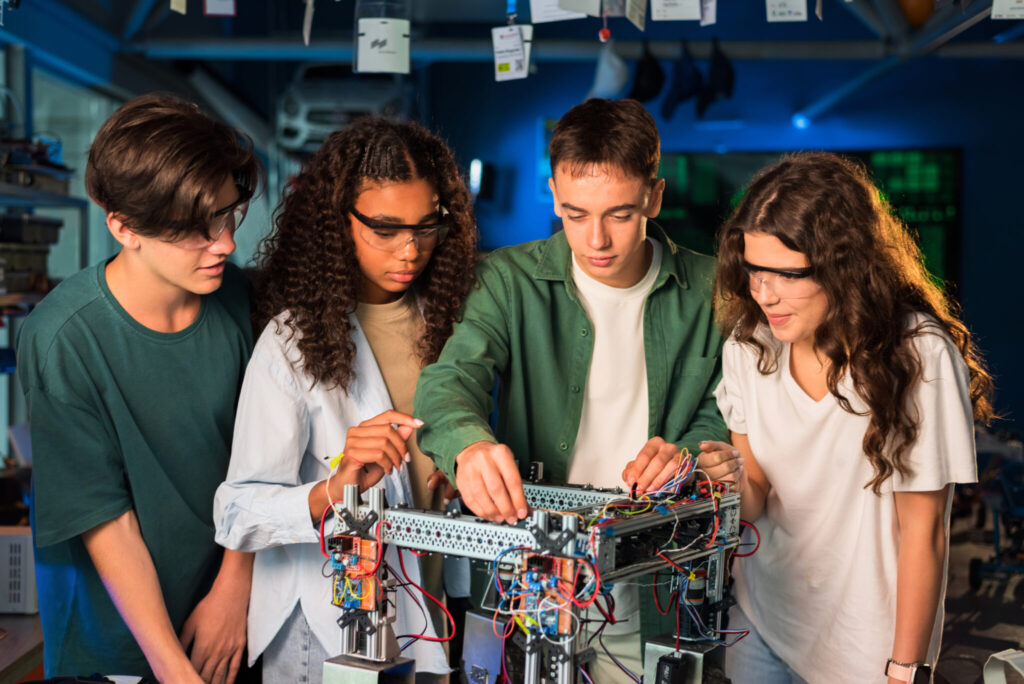 group of young people doing experiments in robotics in a laboratory