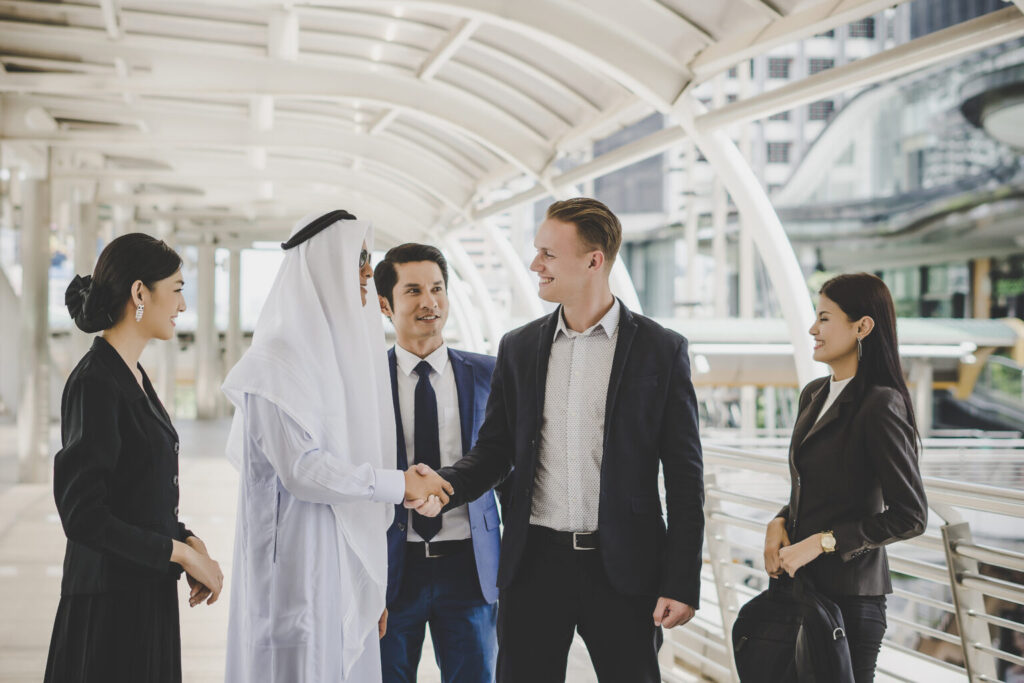 portrait of business partners greeting one another by handshakin