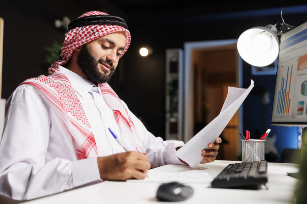 man diligently working at his desk